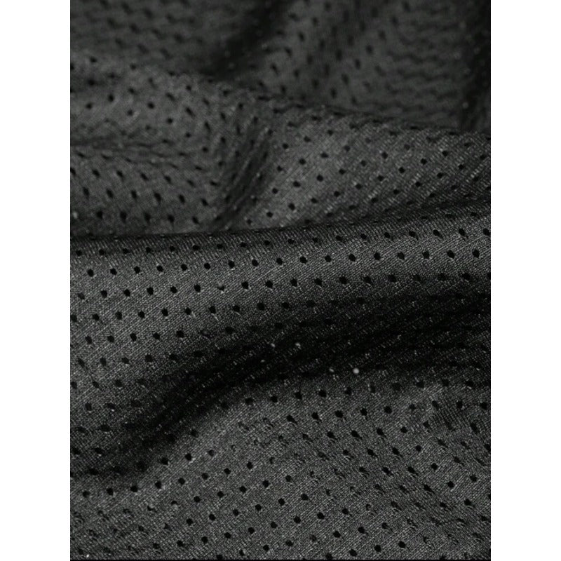Close-up of a Black Football Jersey mesh fabric with a repeating perforated dot pattern, shown with soft folds and shadows.