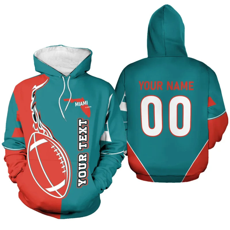Front and back view of a customized Miami football hoodie in aqua teal and orange, featuring a flame football design, Florida state map, and personalized name "YOUR NAME" and number "00" on the back.